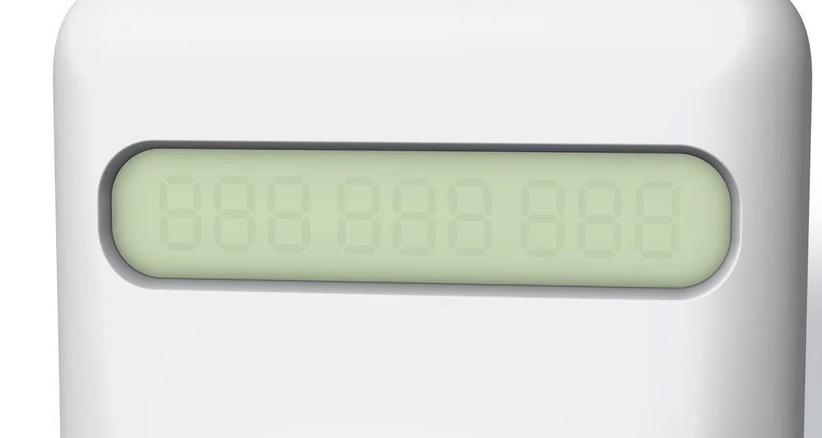 A close-up of the display: dark digits on a pale yellow-green LCD, behind glass