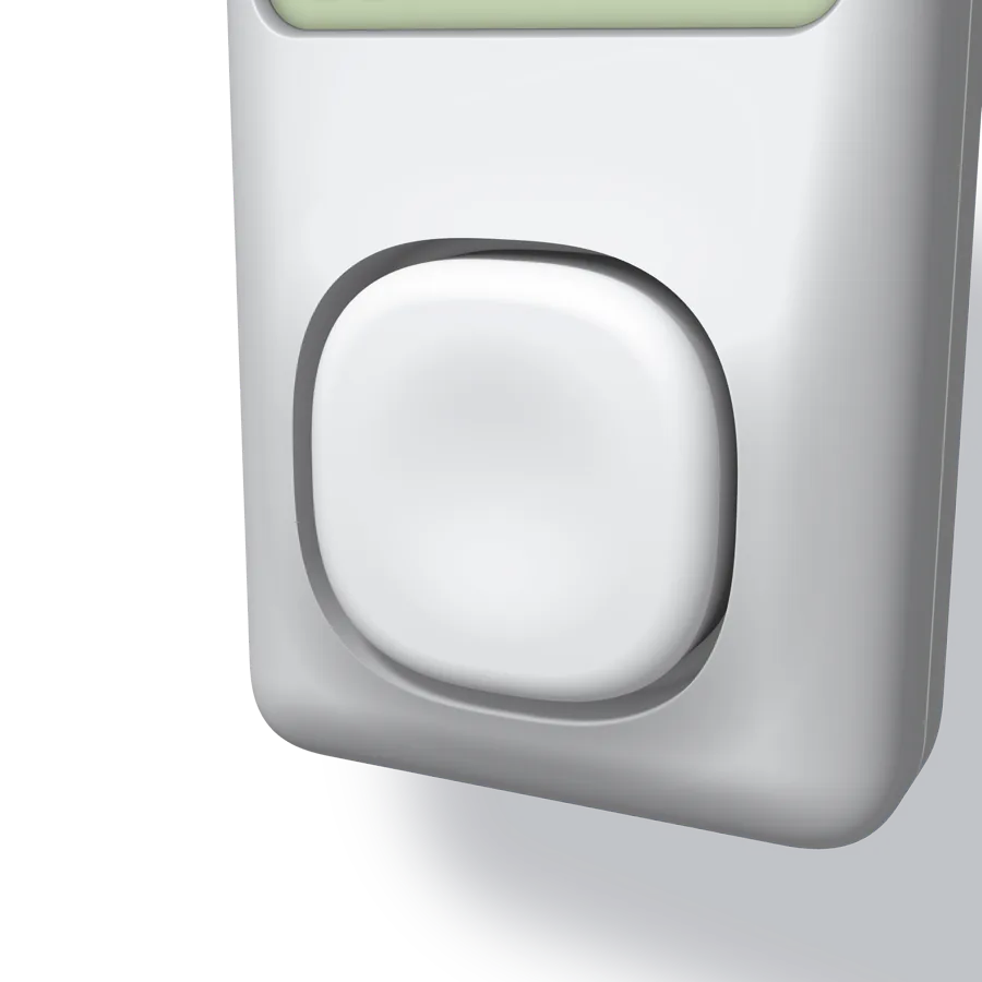 A close-up of the key: a pillow-shaped white cap standing a little proud of a sharp-edged well in the swelled front face
